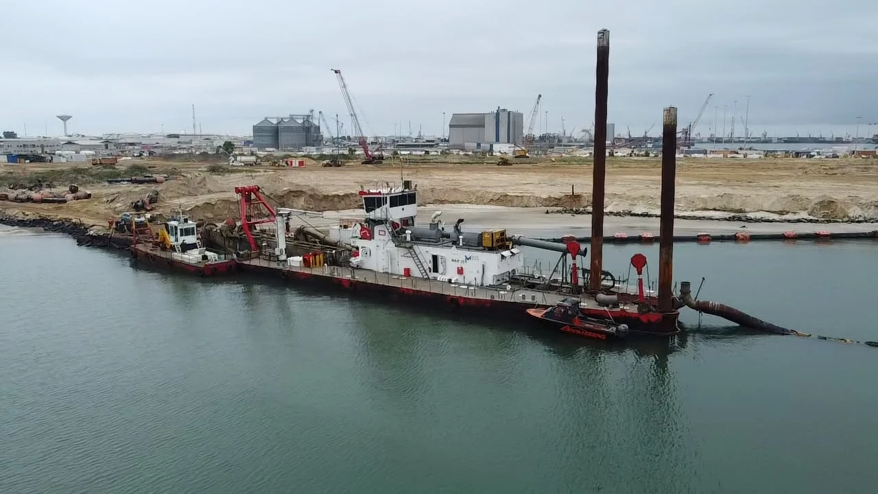 Dredging vessel and floating pipeline at the reclamation works