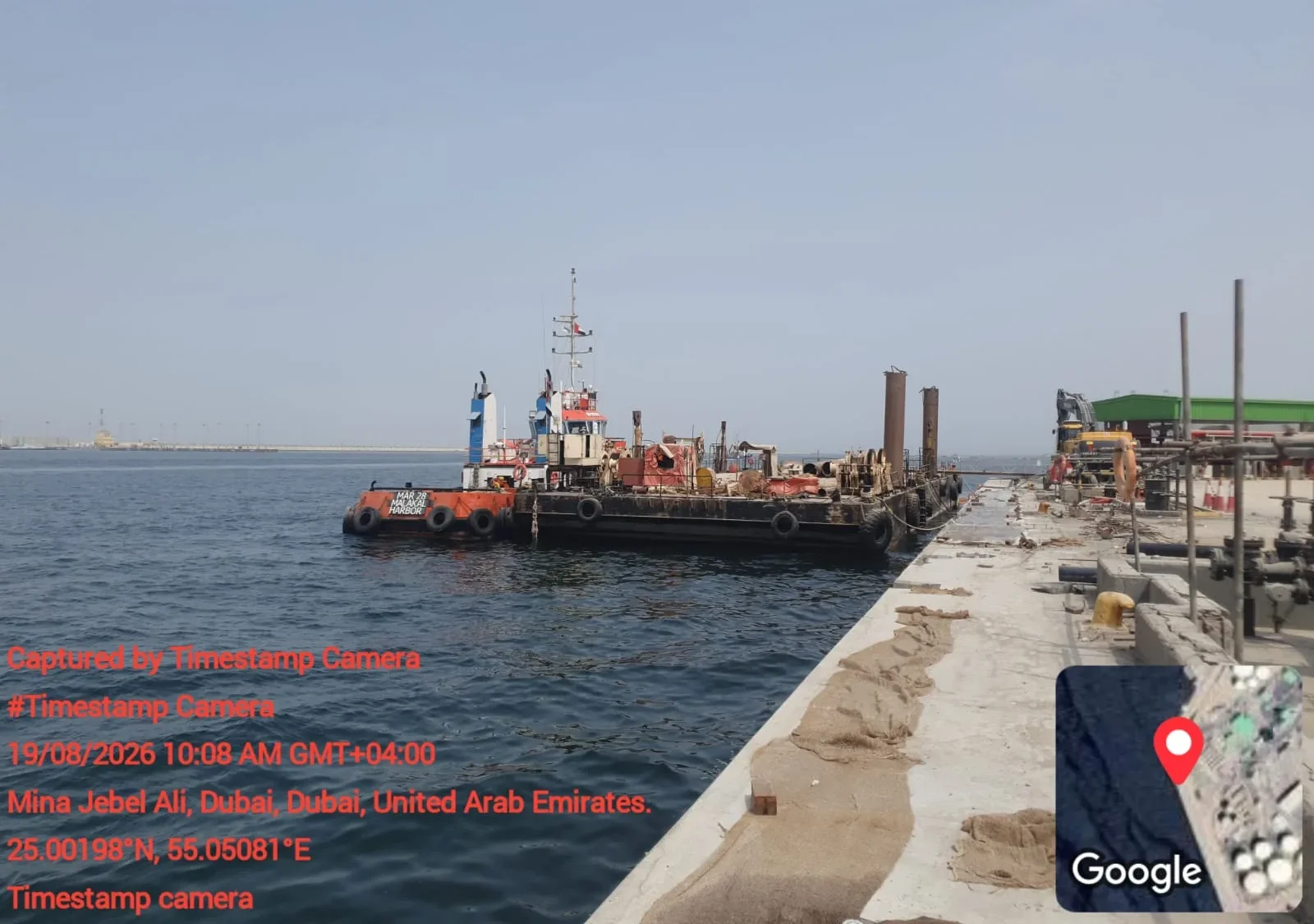 East Wharf, Jebel Ali — barge and tugboat supporting the marine works