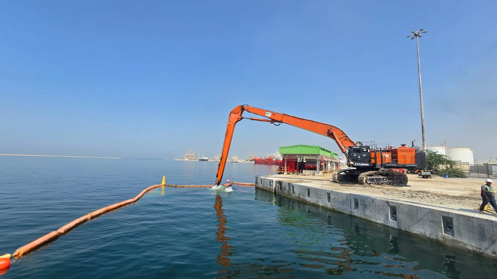 East Wharf, Jebel Ali — long-reach excavator working beside the quay