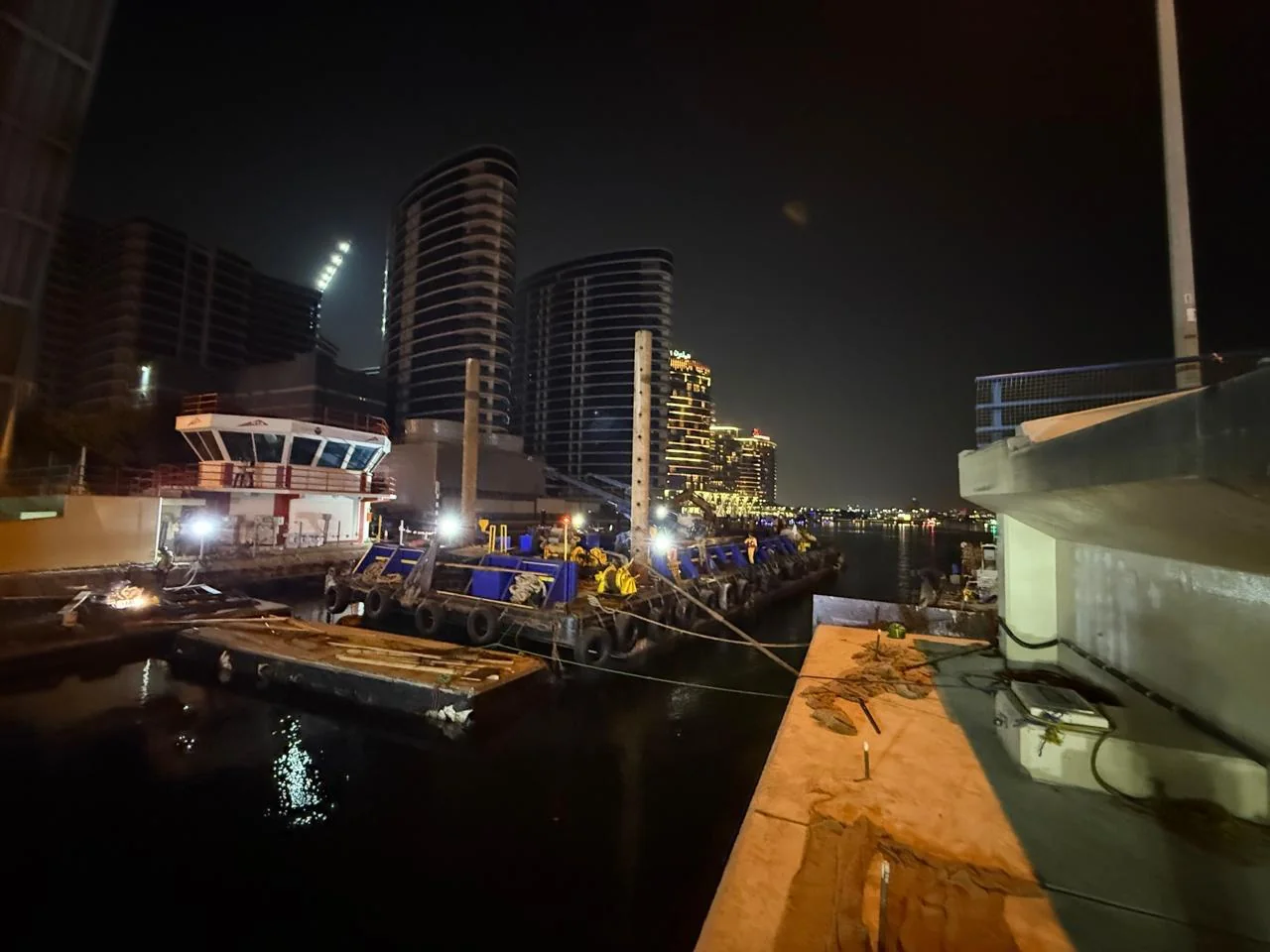 RTA Al Maktoum Bridge — nighttime marine operations beside the bridge
