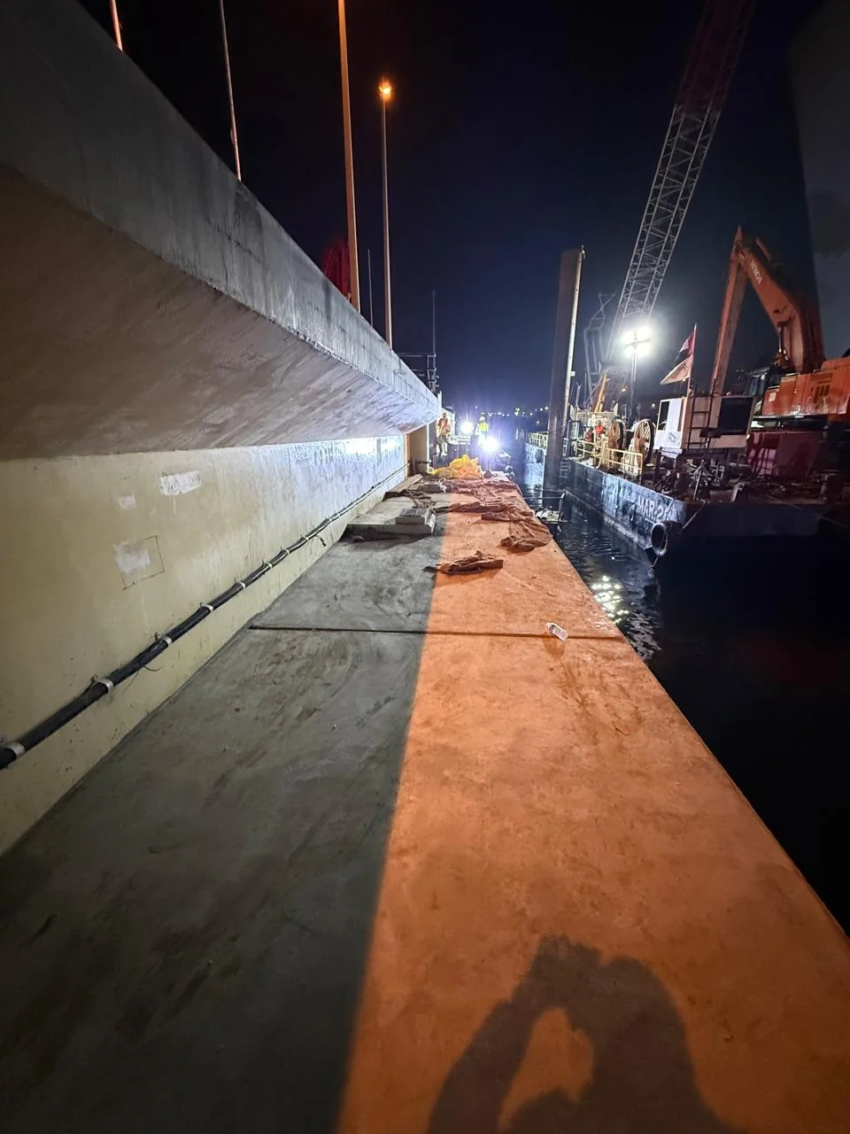 RTA Al Maktoum Bridge — nighttime works along the creek-side wall